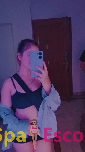 Navi Mumbai escort preparing wine in a cozy hotel suite.